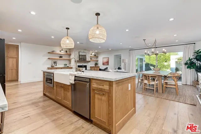 a kitchen with stainless steel appliances granite countertop a stove and a wooden floors