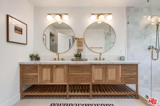 a bathroom with a sink mirror and vanity