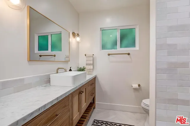 a bathroom with a sink a toilet and a shower