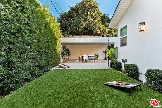 a view of a backyard with plants and a patio
