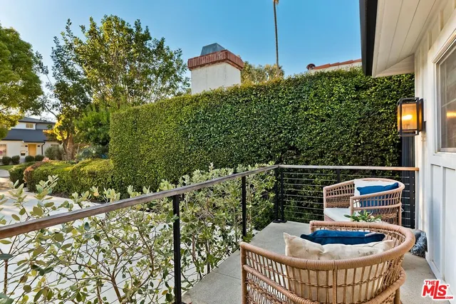 a balcony with table and chairs