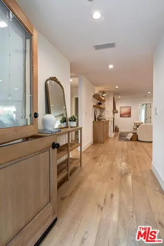 a kitchen with a refrigerator and a stove top oven
