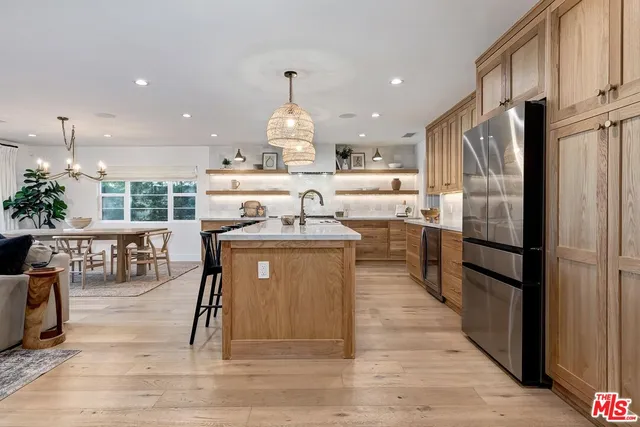 a kitchen with stainless steel appliances granite countertop a refrigerator sink and cabinets