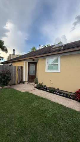 a front view of a house with a garden and yard