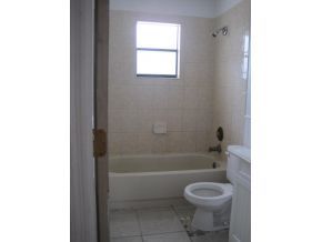 120 Southwest Ware Palm Bay, FL 32908 - Photo 8 of 11 a bathroom with a toilet and a bathtub