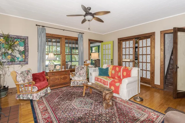 a living room with furniture rug and wooden floor