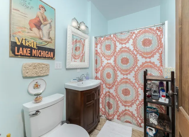 a bathroom with a toilet and a shower curtain