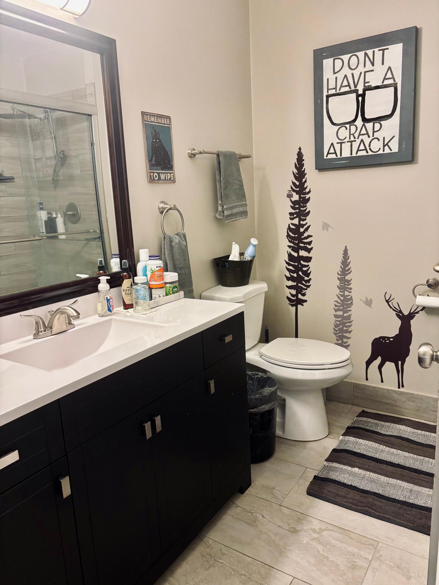 2819 Bryant Street Portage, IN 46368 - Photo 6 of 24 a bathroom with a toilet sink and mirror