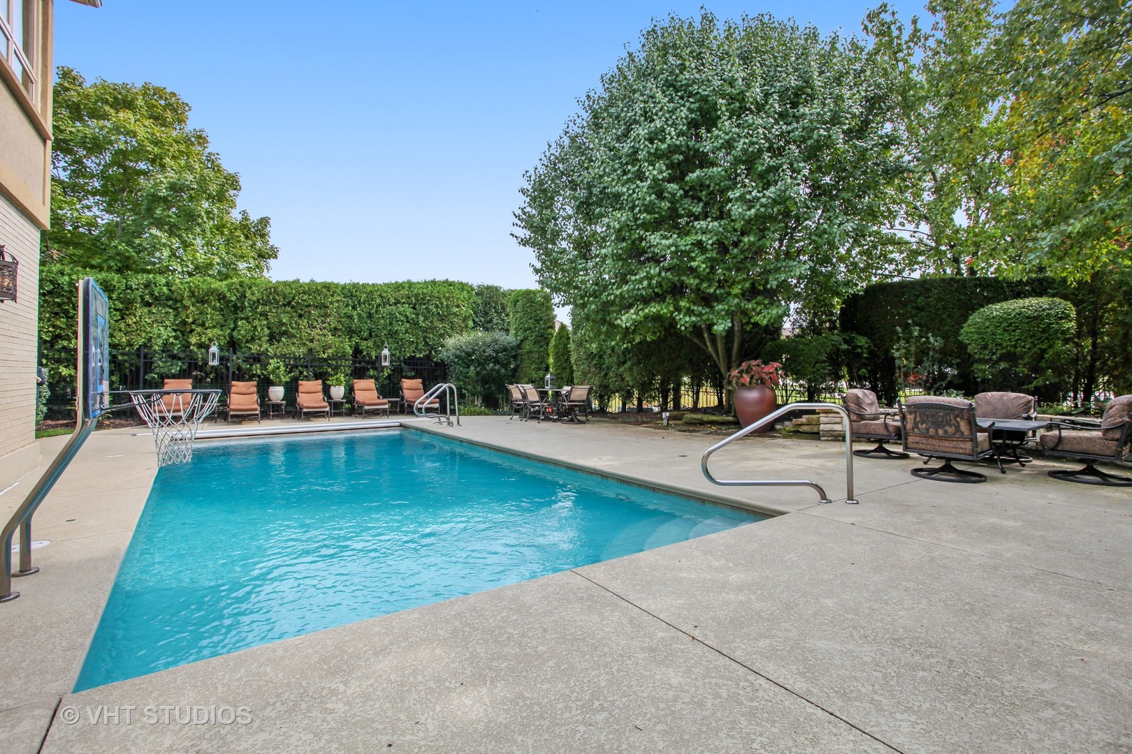 1536 Voltz Road Northbrook, IL 60062 - Photo 34 of 50 a view of a swimming pool with lawn chairs and a fire pit