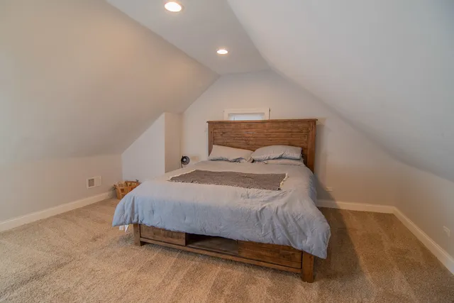 a bedroom with a bed and a night stand