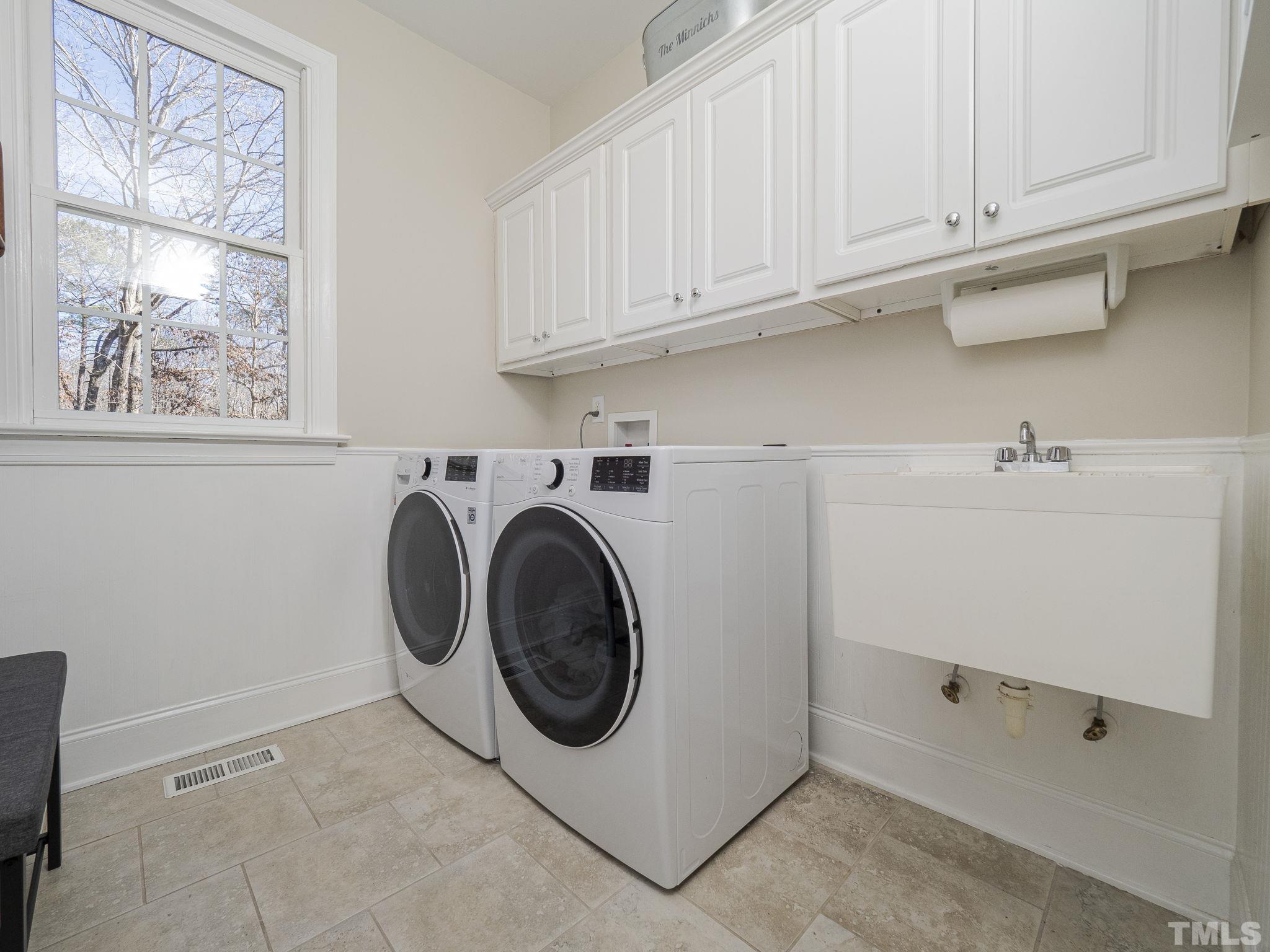 7112 Anglesey Court Wake Forest, NC 27587 - Photo 11 of 23 a utility room with sink dryer and washer