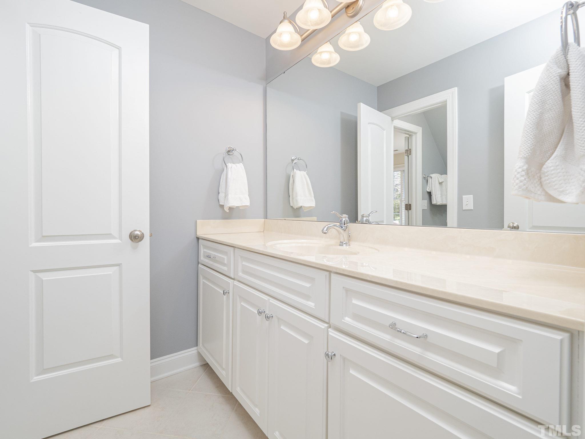 7112 Anglesey Court Wake Forest, NC 27587 - Photo 15 of 23 a bathroom with a sink and a mirror