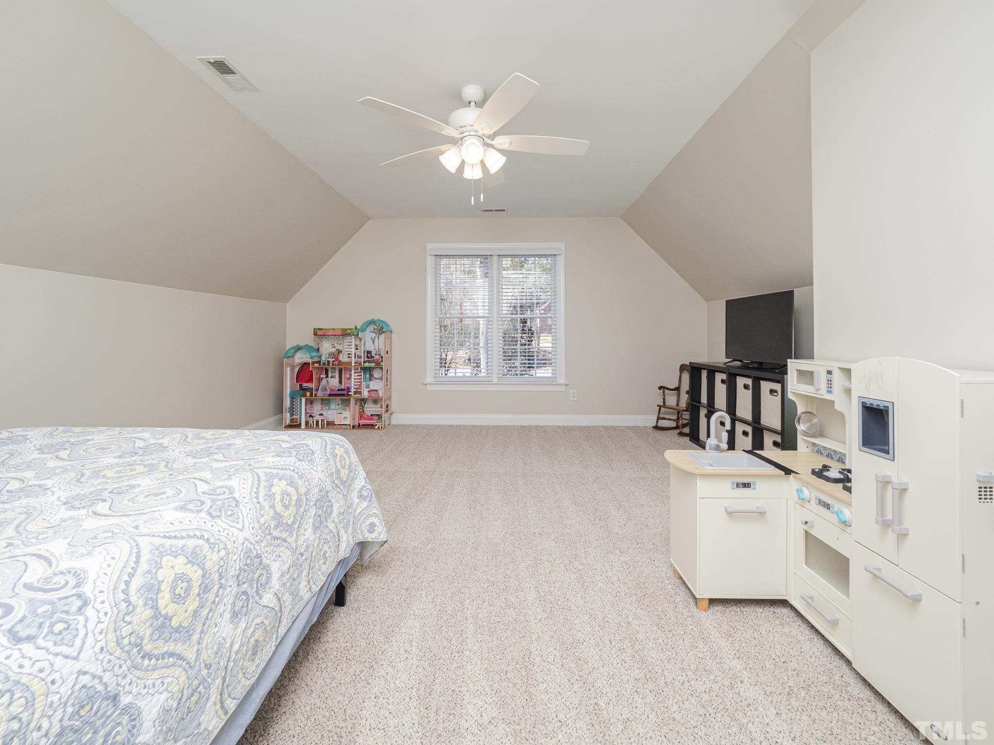 7112 Anglesey Court Wake Forest, NC 27587 - Photo 16 of 23 a spacious bedroom with a bed and a large window