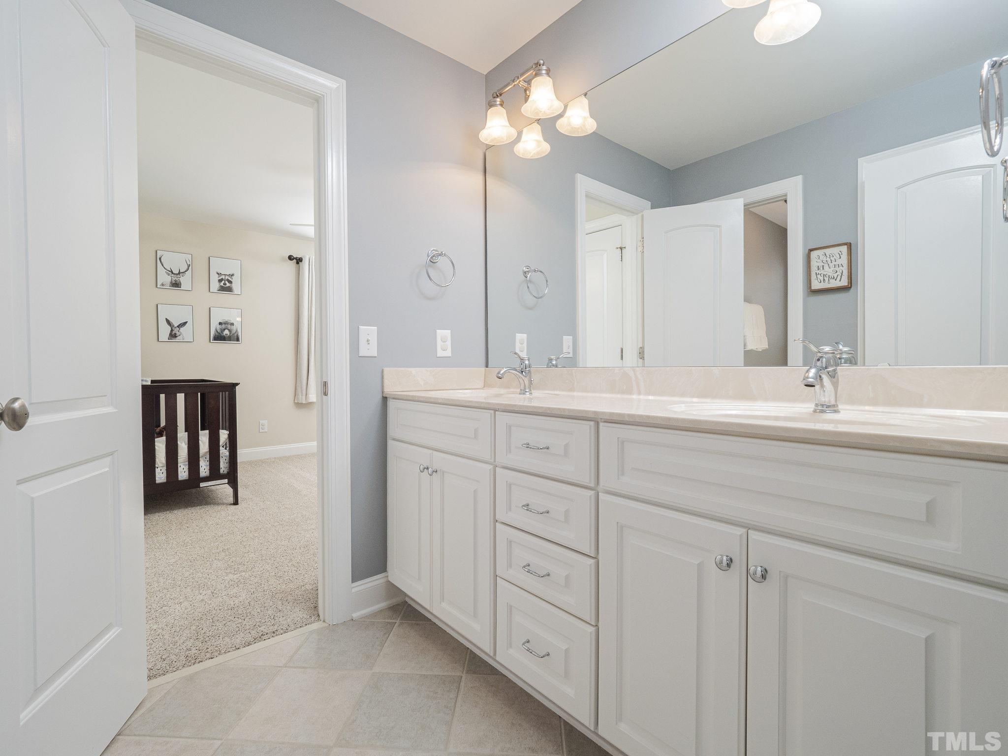 7112 Anglesey Court Wake Forest, NC 27587 - Photo 18 of 23 a bathroom with a double vanity sink mirror and