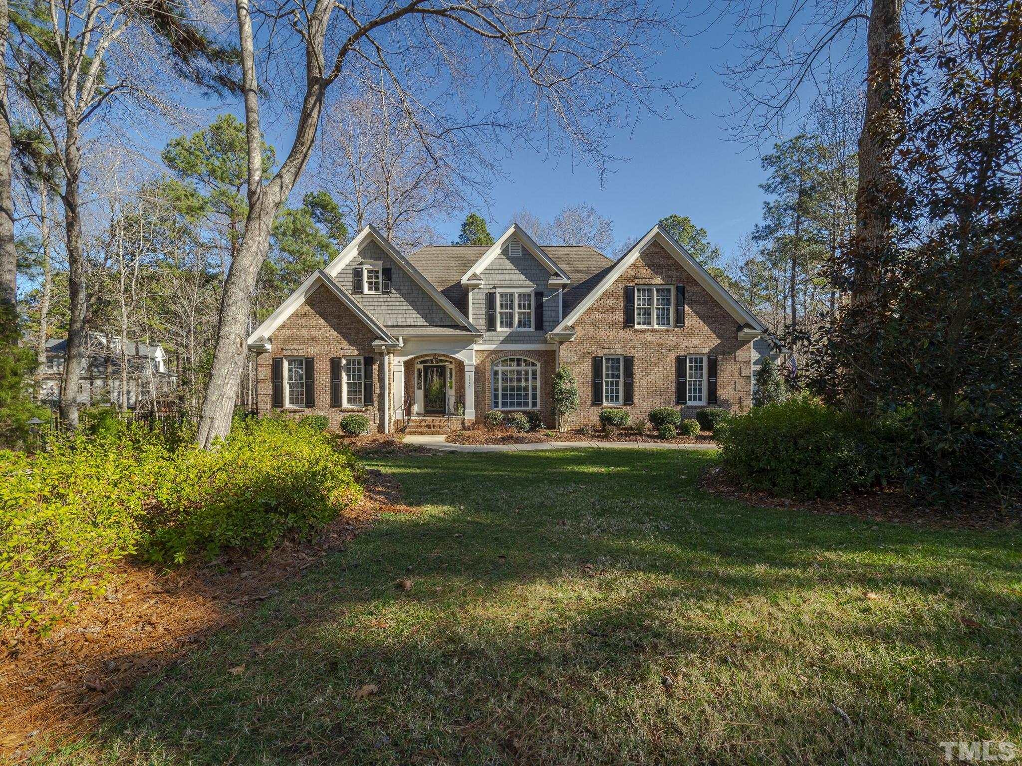 7112 Anglesey Court Wake Forest, NC 27587 - Photo 2 of 23 a front view of a house with a garden
