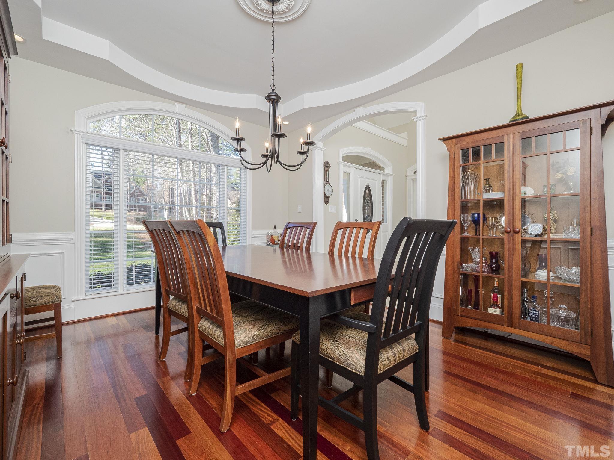 7112 Anglesey Court Wake Forest, NC 27587 - Photo 6 of 23 a view of a dining room with furniture wooden floor and chandelier