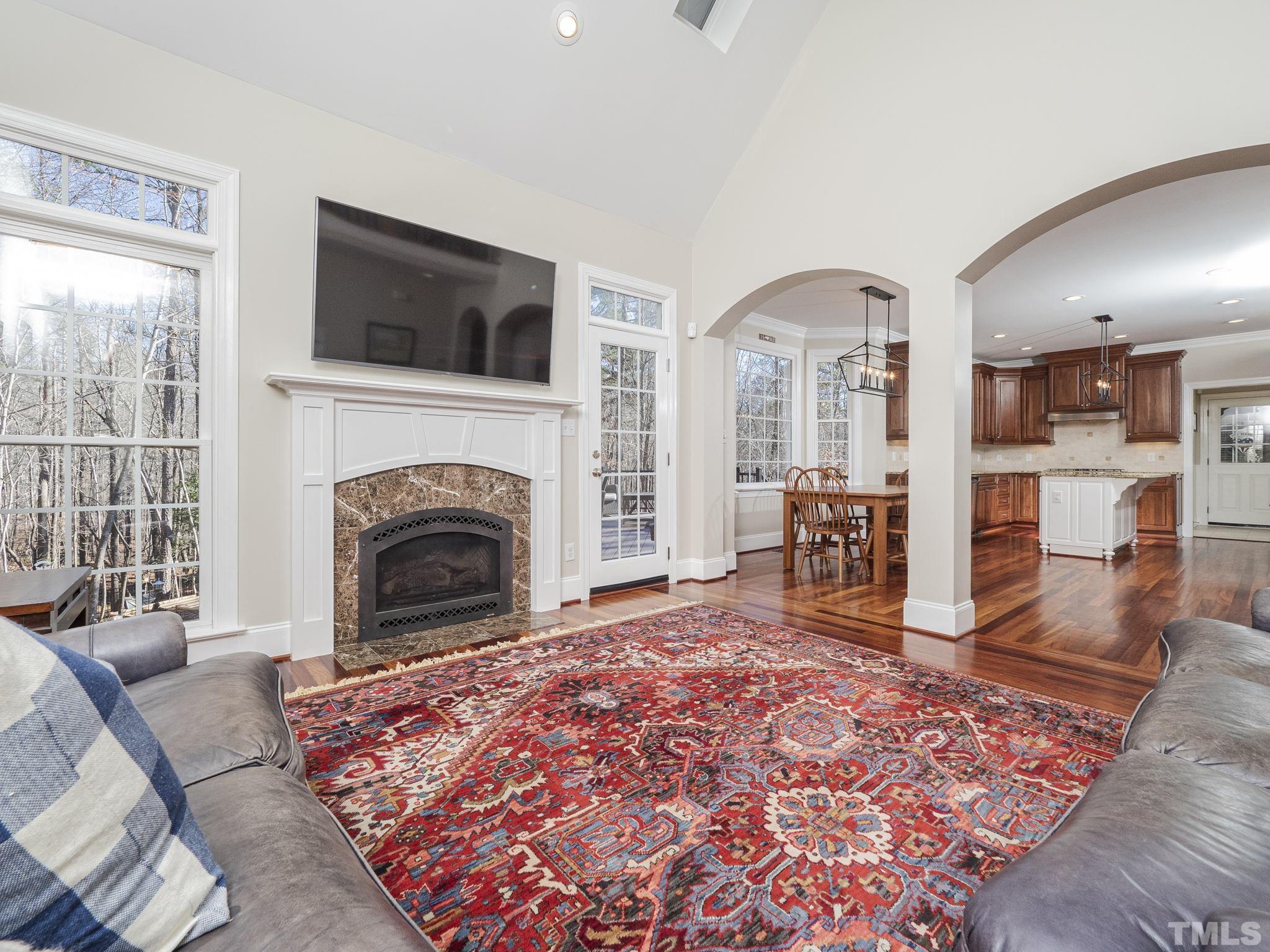 7112 Anglesey Court Wake Forest, NC 27587 - Photo 7 of 23 a living room with a large fireplace and a rug