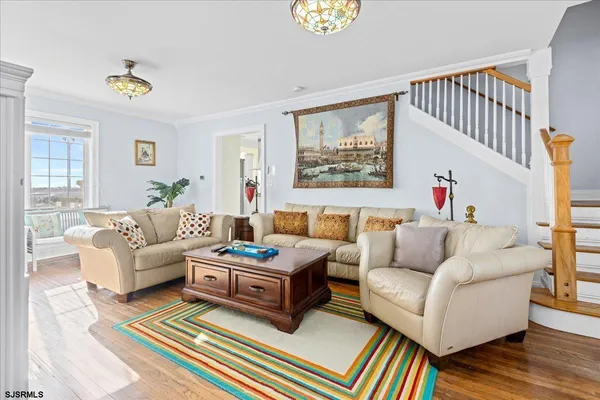 a living room with furniture fireplace and a window