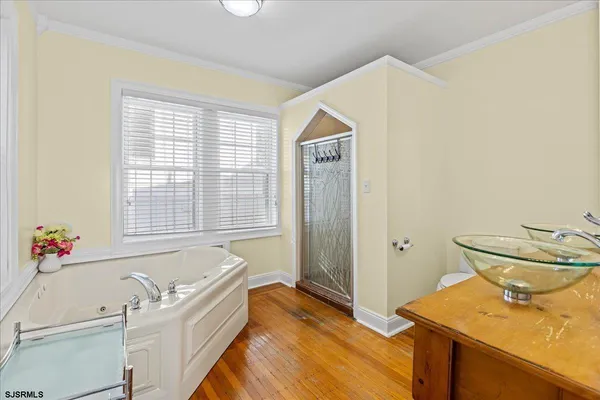 a bathroom with a sink a toilet and a window