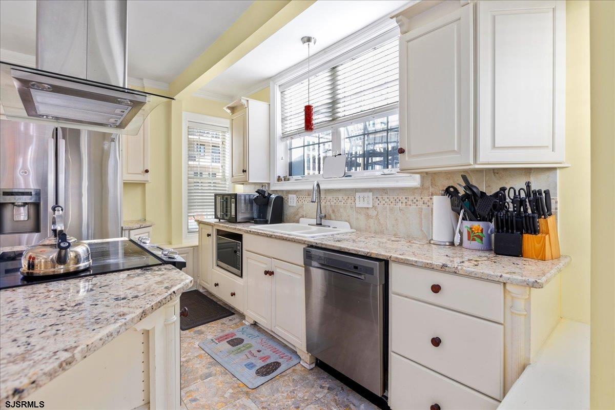 104 South Oakland Avenue, Unit JUNE '26 Ventnor City, NJ 08406 - Photo 9 of 57 a kitchen with granite countertop a sink and cabinets