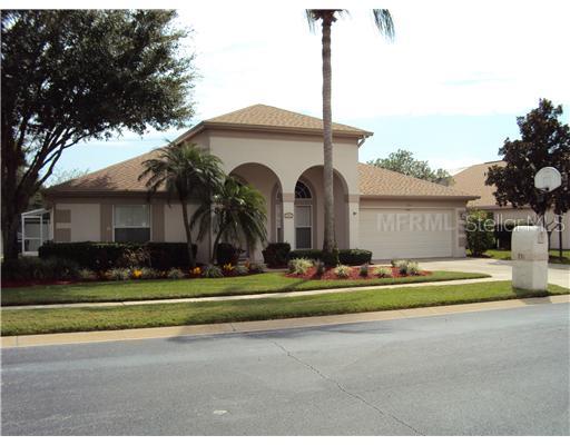 931 Grovesmere Loop Ocoee, FL 34761 - Photo 1 of 1 a front view of a house with a garden and trees