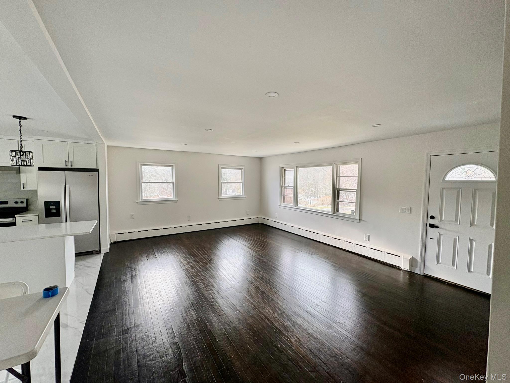 5852 State Rte 55 Liberty, NY 12754 - Photo 12 of 44 a view of a livingroom with wooden floor and a window