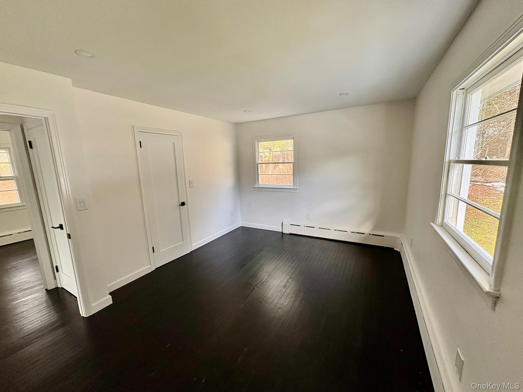 5852 State Rte 55 Liberty, NY 12754 - Photo 15 of 44 an empty room with wooden floor and windows