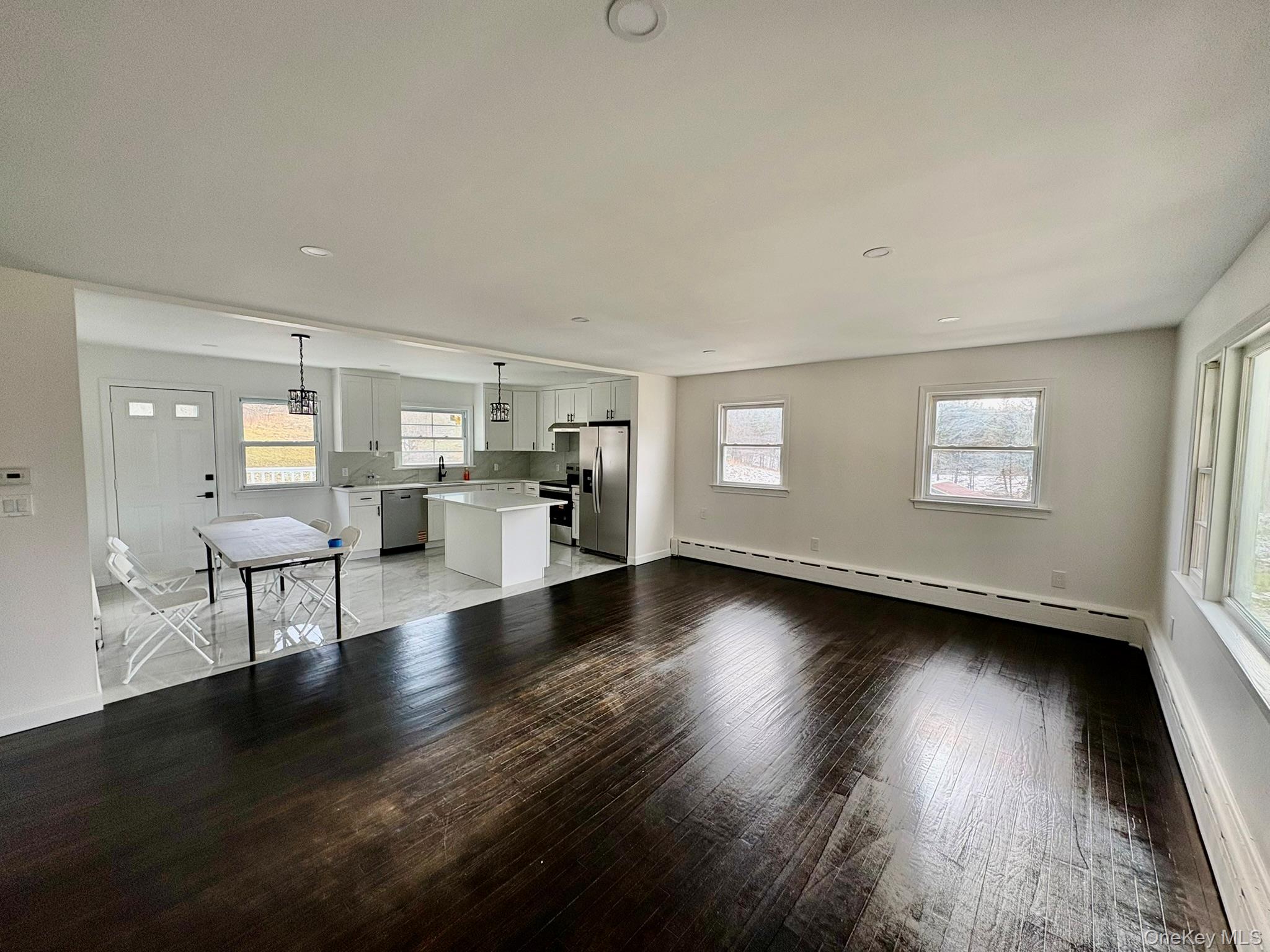 5852 State Rte 55 Liberty, NY 12754 - Photo 3 of 44 a view of an empty room with a window and wooden floor