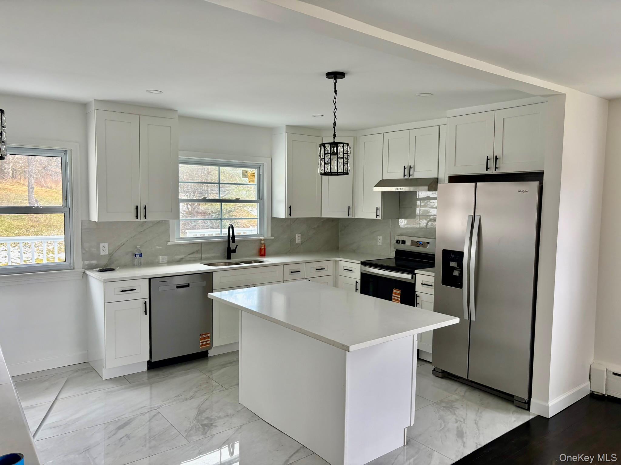 5852 State Rte 55 Liberty, NY 12754 - Photo 6 of 44 a kitchen with stainless steel appliances granite countertop a refrigerator a sink dishwasher a oven and a refrigerator with wooden floor