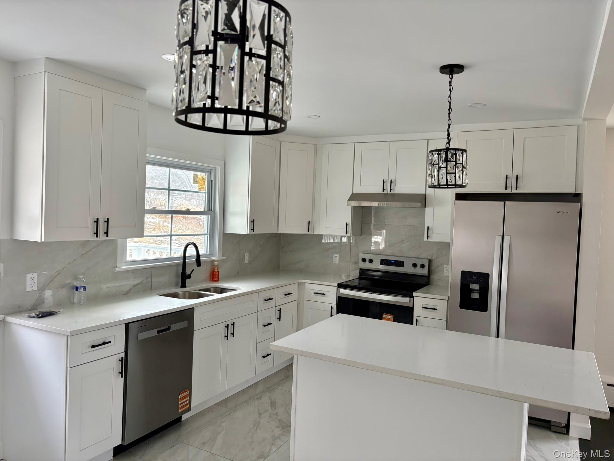 5852 State Rte 55 Liberty, NY 12754 - Photo 7 of 44 a kitchen with cabinets a window and stainless steel appliances