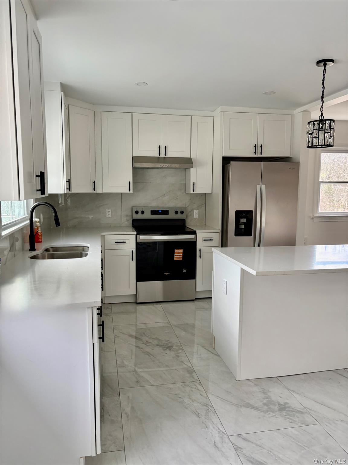 5852 State Rte 55 Liberty, NY 12754 - Photo 9 of 44 a kitchen with stainless steel appliances granite countertop a stove a sink and a microwave