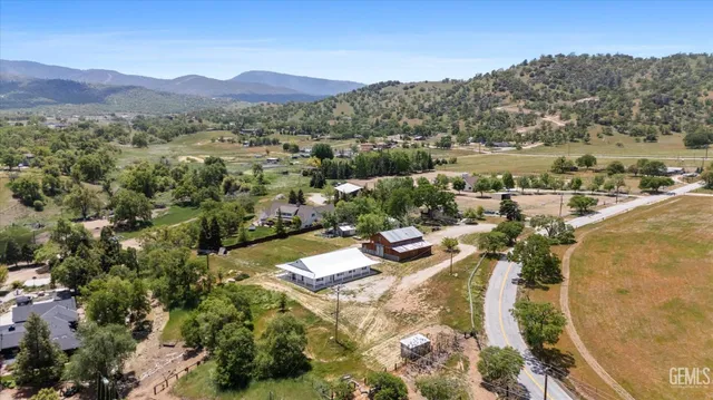 an aerial view of a house with a yard and lake view