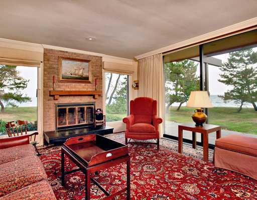 253 Long Neck Point Road Darien, CT 06820 - Photo 11 of 15 a living room with furniture a fireplace and a floor to ceiling window