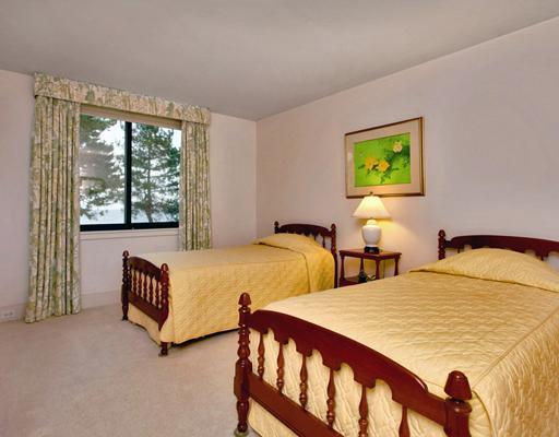 253 Long Neck Point Road Darien, CT 06820 - Photo 14 of 15 a bedroom with two beds and a large window