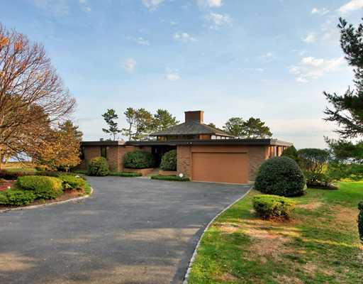 253 Long Neck Point Road Darien, CT 06820 - Photo 6 of 15 a house with green field in front of it