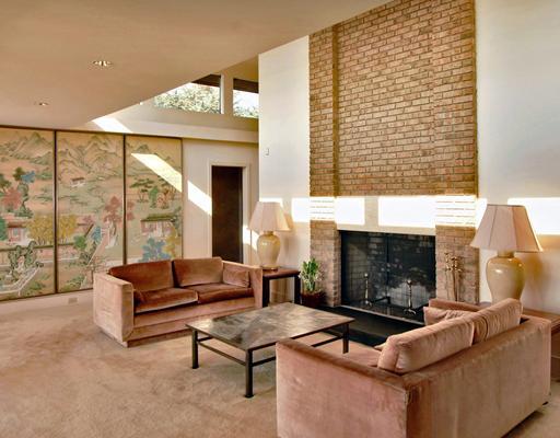 253 Long Neck Point Road Darien, CT 06820 - Photo 7 of 15 a living room with furniture a fireplace and a floor to ceiling window
