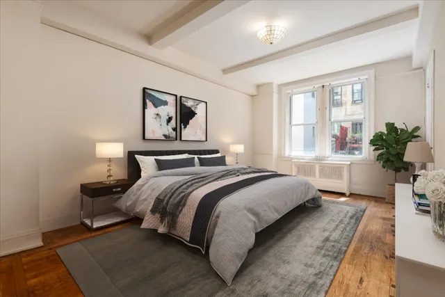 a bedroom with bed and a potted plant