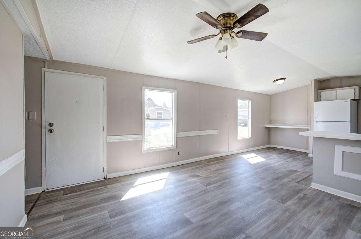 14 High Bluff Road Northeast Rome, GA 30165 - Photo 11 of 29 wooden floor in an empty room with a window