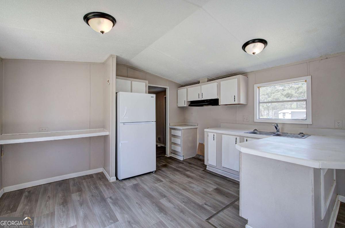 14 High Bluff Road Northeast Rome, GA 30165 - Photo 13 of 29 a kitchen with a refrigerator sink and cabinets