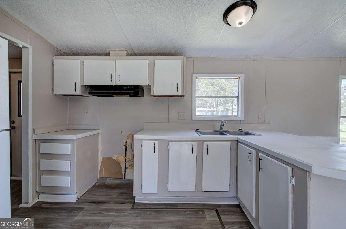 14 High Bluff Road Northeast Rome, GA 30165 - Photo 17 of 29 a view of cabinets and wooden floor