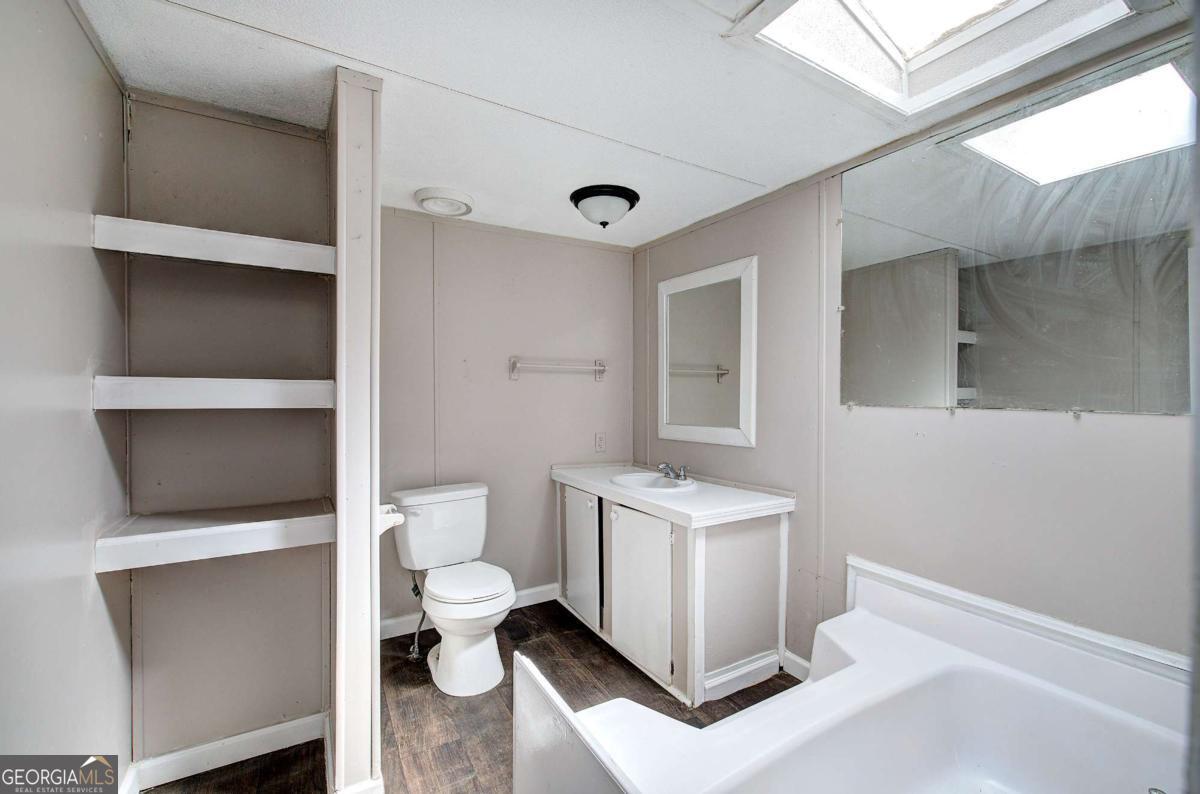 14 High Bluff Road Northeast Rome, GA 30165 - Photo 21 of 29 a bathroom with a toilet sink and mirror