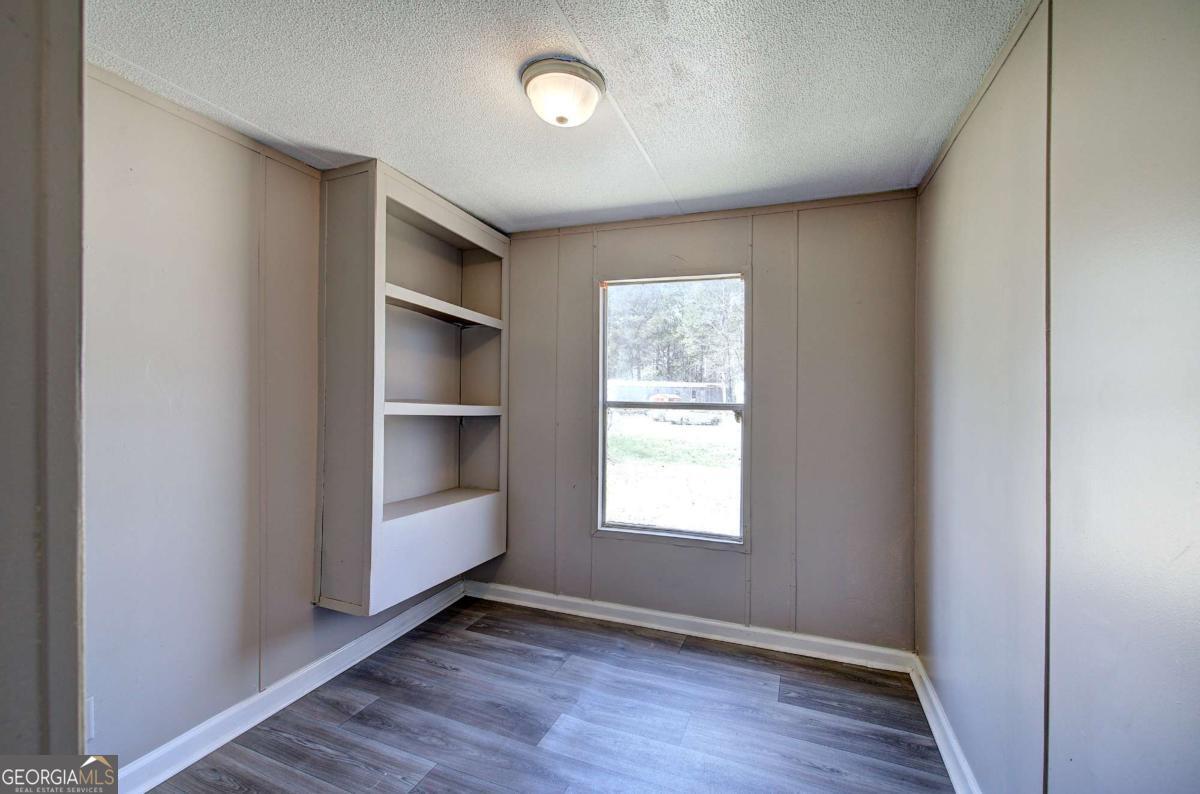 14 High Bluff Road Northeast Rome, GA 30165 - Photo 24 of 29 an empty room with wooden floor closet and windows