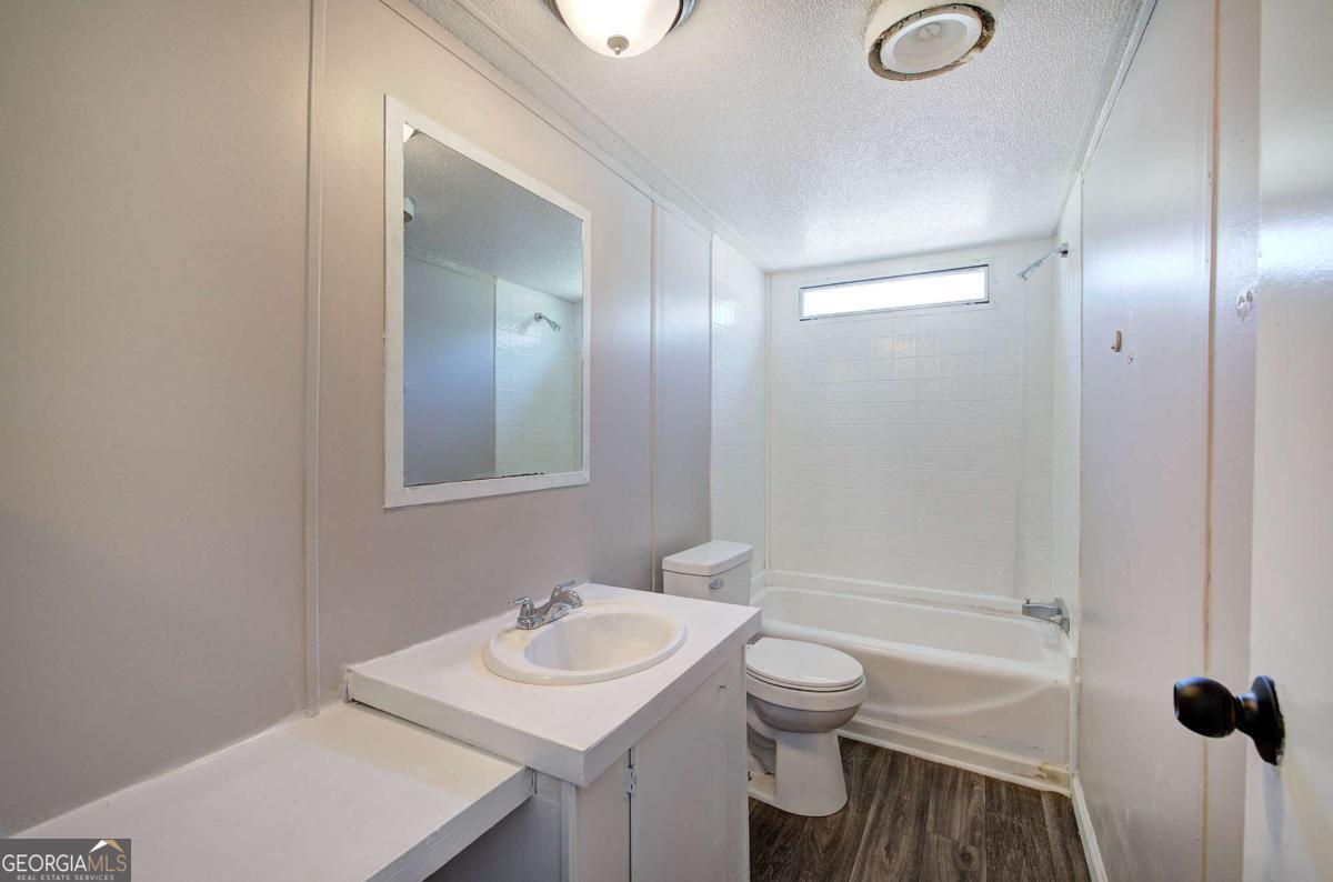 14 High Bluff Road Northeast Rome, GA 30165 - Photo 26 of 29 a bathroom with a sink toilet and shower