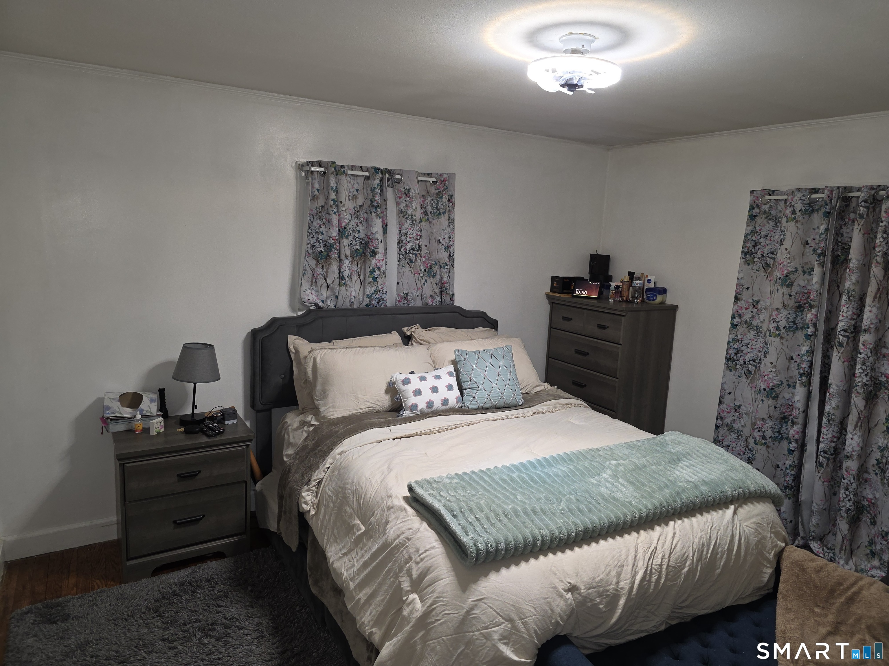 29 Esther Avenue Waterbury, CT 06708 - Photo 11 of 25 a bedroom with a bed and a chandelier