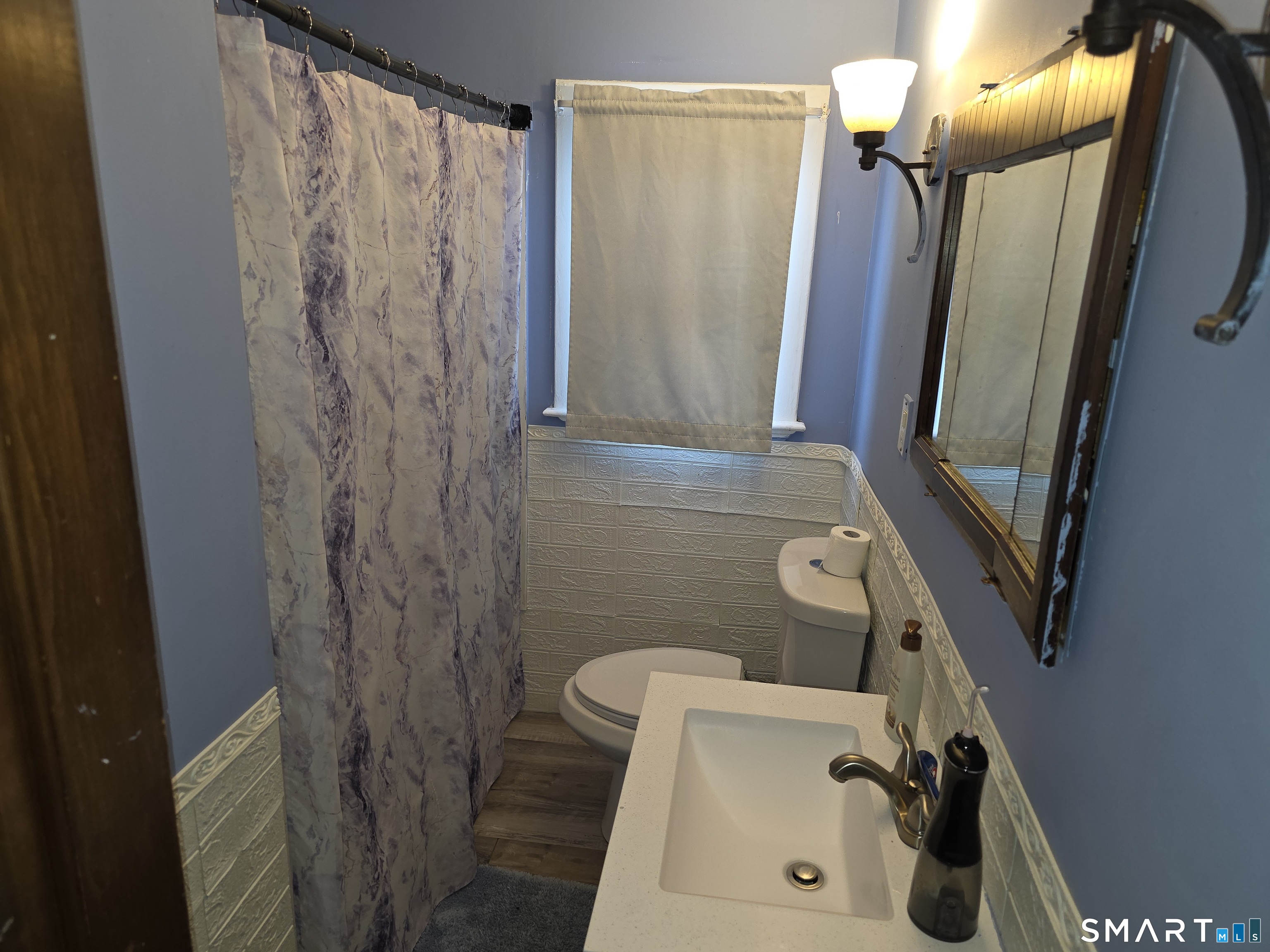 29 Esther Avenue Waterbury, CT 06708 - Photo 18 of 25 a bathroom with a sink a mirror a shower and vanity
