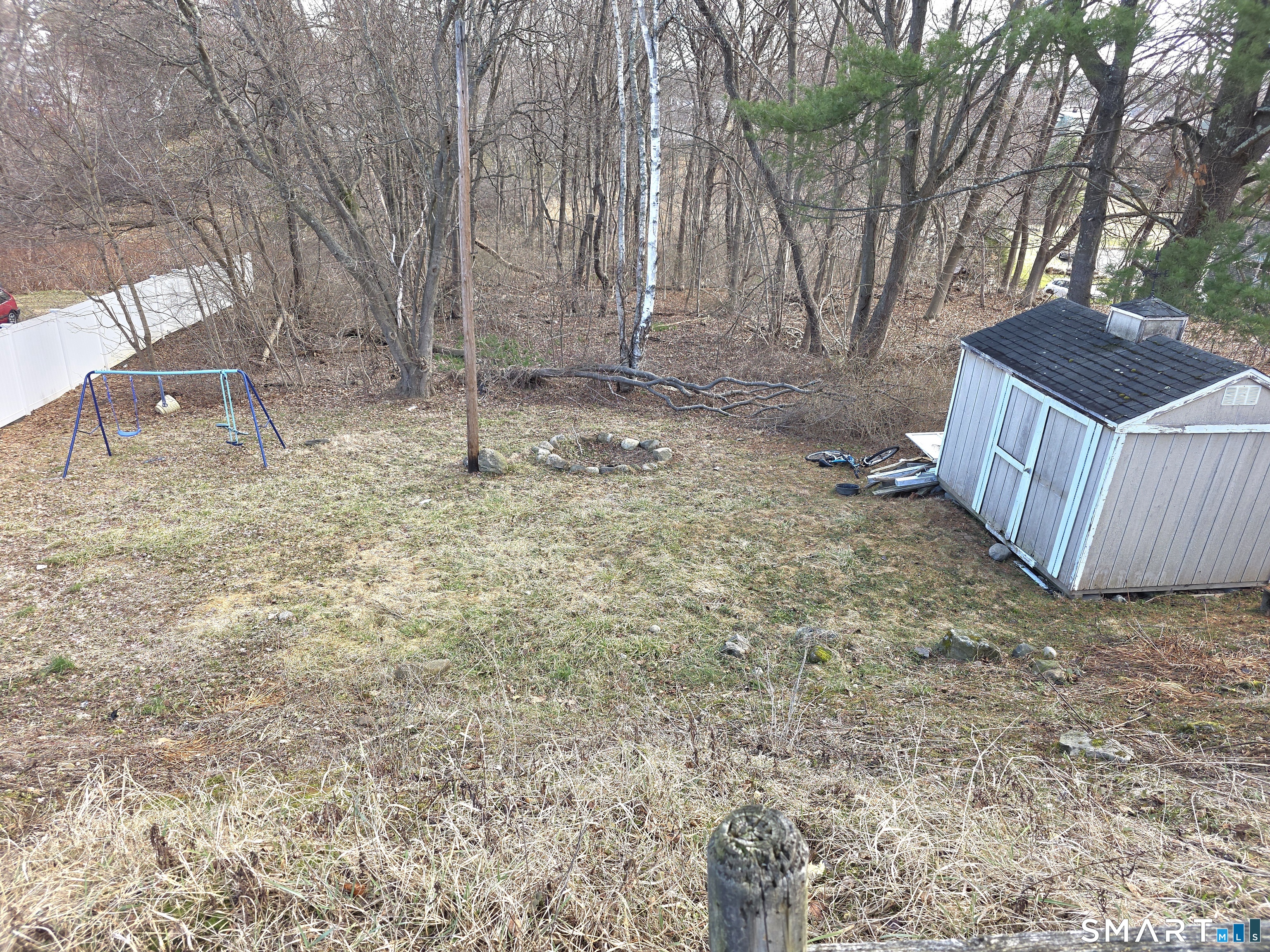 29 Esther Avenue Waterbury, CT 06708 - Photo 20 of 25 a view of backyard with wooden fence and large trees