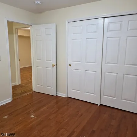 a view of an empty room and wooden floor