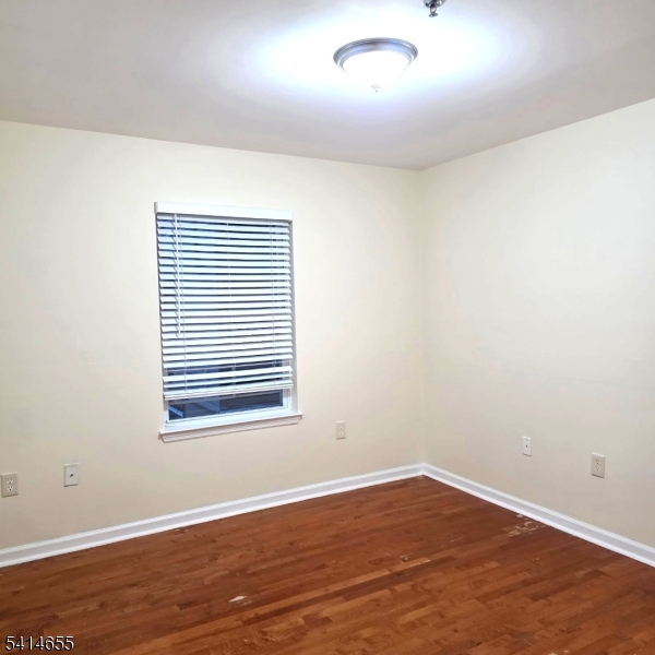 24 Van Vechten Street, Unit 3 Newark, NJ 07114 - Photo 27 of 36 an empty room with wooden floor and windows