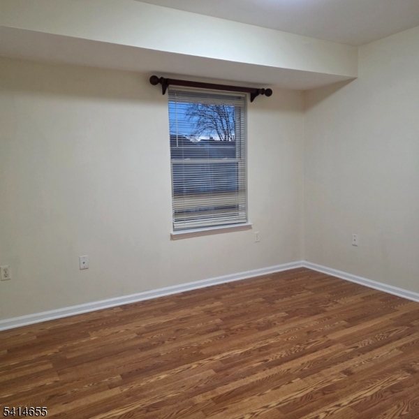 24 Van Vechten Street, Unit 3 Newark, NJ 07114 - Photo 32 of 36 a view of empty room with wooden floor and fan