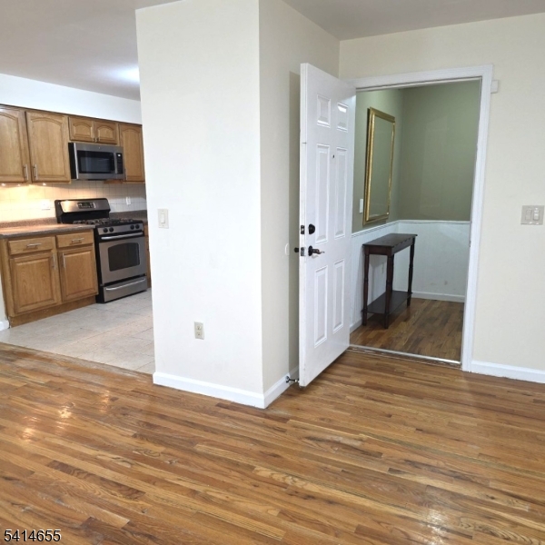 24 Van Vechten Street, Unit 3 Newark, NJ 07114 - Photo 4 of 36 a view of a kitchen from the hallway
